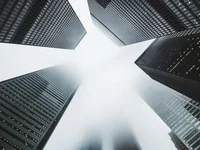 Towering structures disappearing into cloudy sky