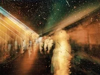 Faded photograph of a person on street