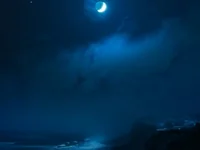 Coast illuminated by blue hue moonlight