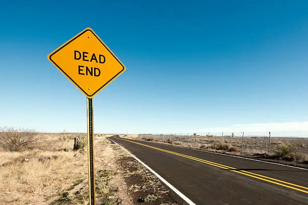 Picture of a dead end sign at the end of the road